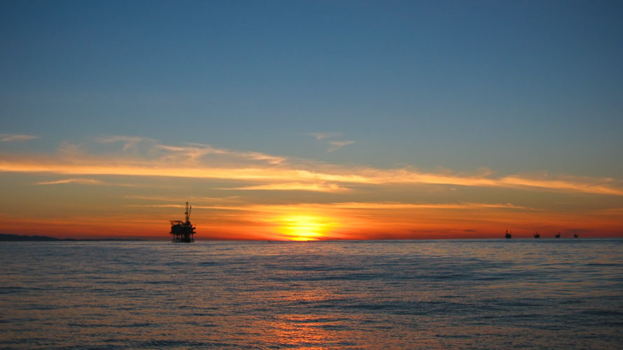 oils rigs line up to watch the sunset