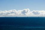 storm clouds over oil rigs